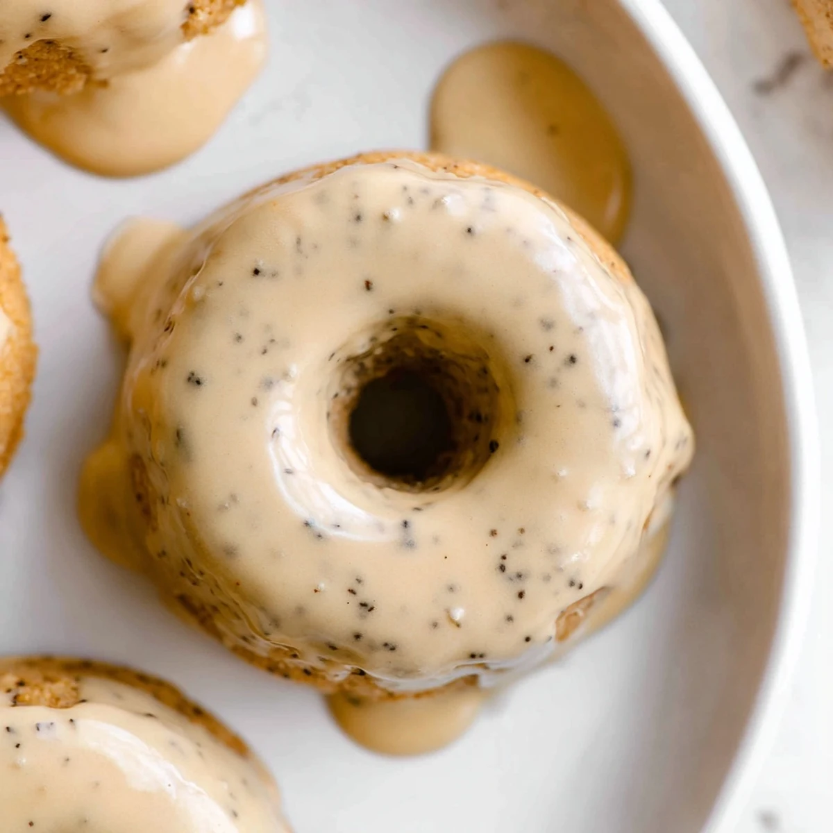 Chewy homemade Earl Grey mochi donuts topped with sweet vanilla glaze and dotted tea leaves