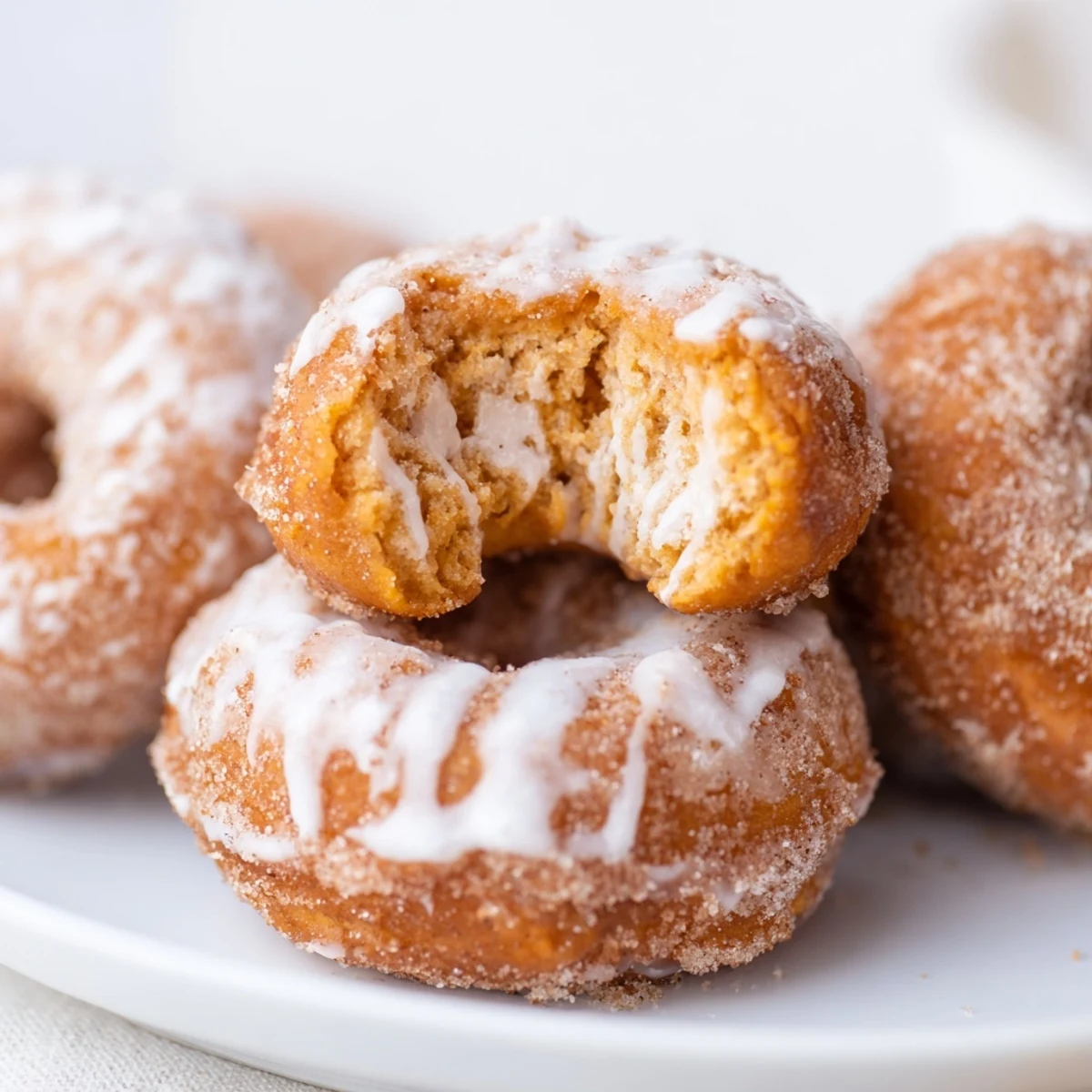Soft fluffy pumpkin donuts fried to golden perfection with warm autumn spices