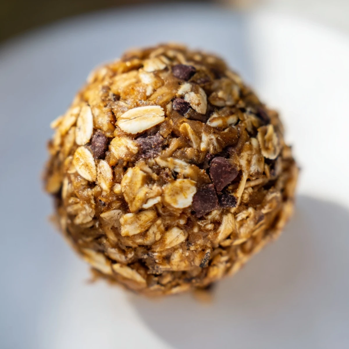 Golden no bake peanut butter energy bites rolled into bite-sized balls studded with melty chocolate chips