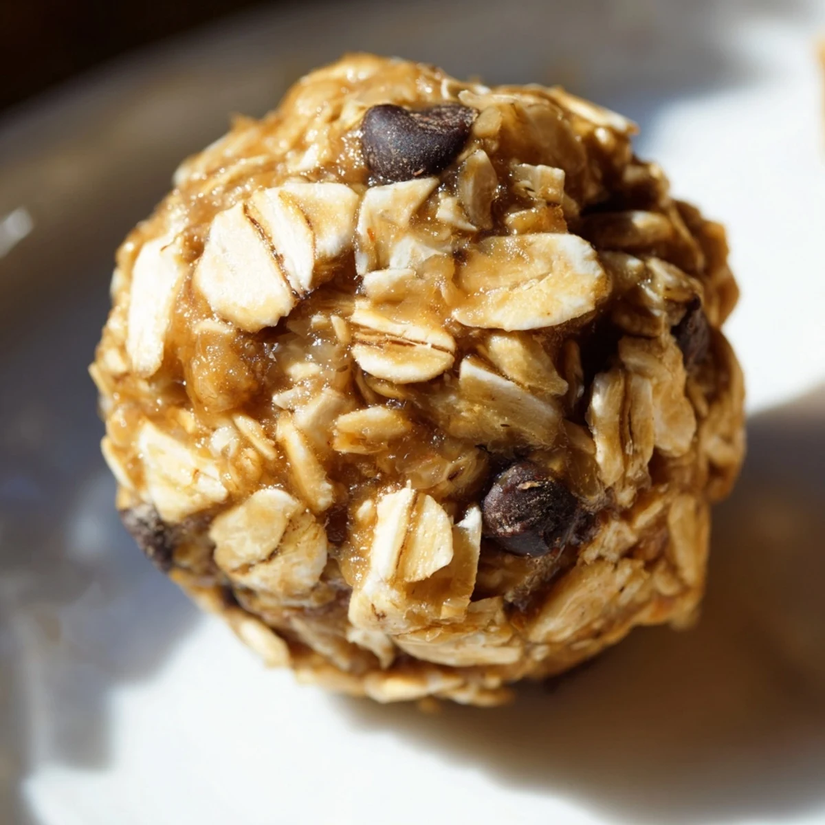 Close-up of homemade no bake peanut butter energy bites showing their rich crumbly texture and chocolate chip flecks