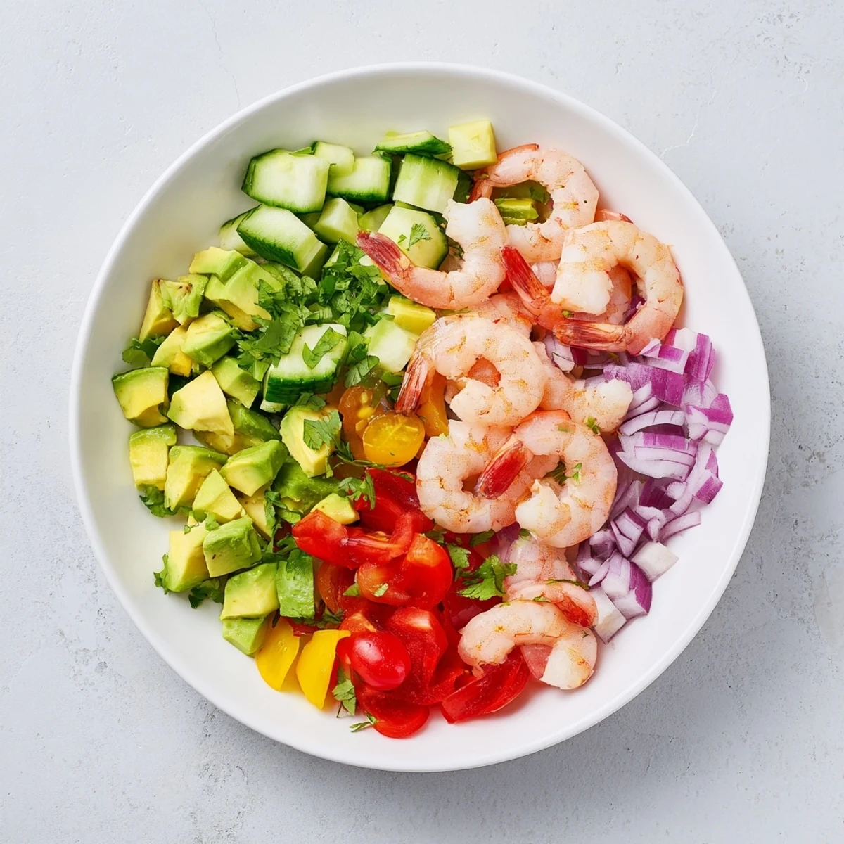 Plate of healthy shrimp avocado salad featuring pink succulent shrimp and creamy green avocado chunks