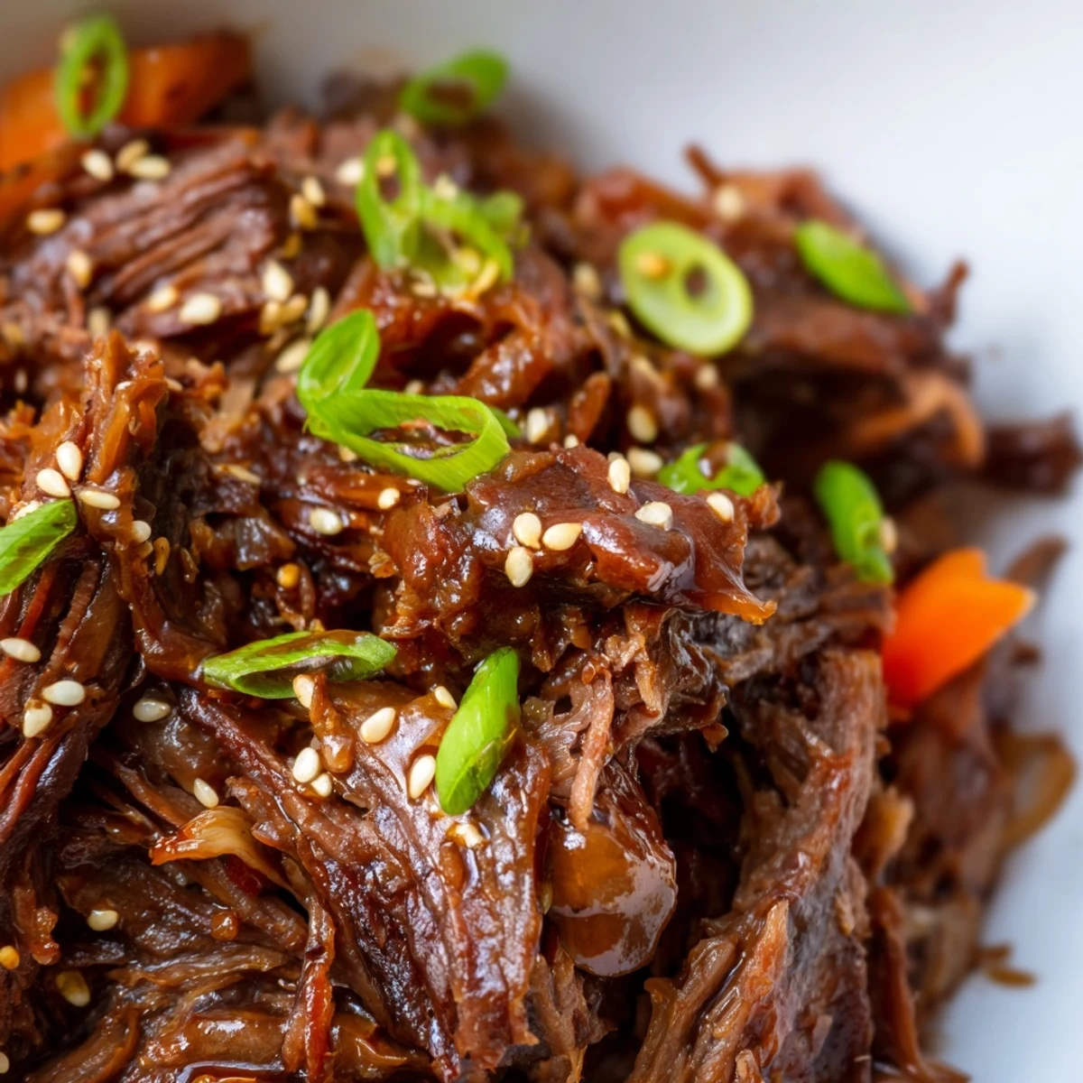 Tender Korean style pot roast with shredded beef glazed in savory soy sesame sauce