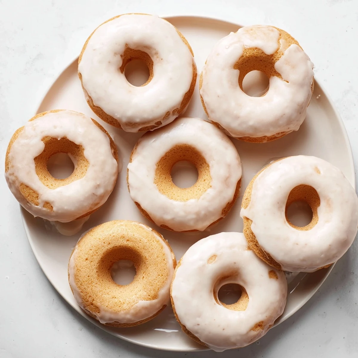 Moist Greek yogurt cake donuts dipped in white powdered sugar glaze ready to serve