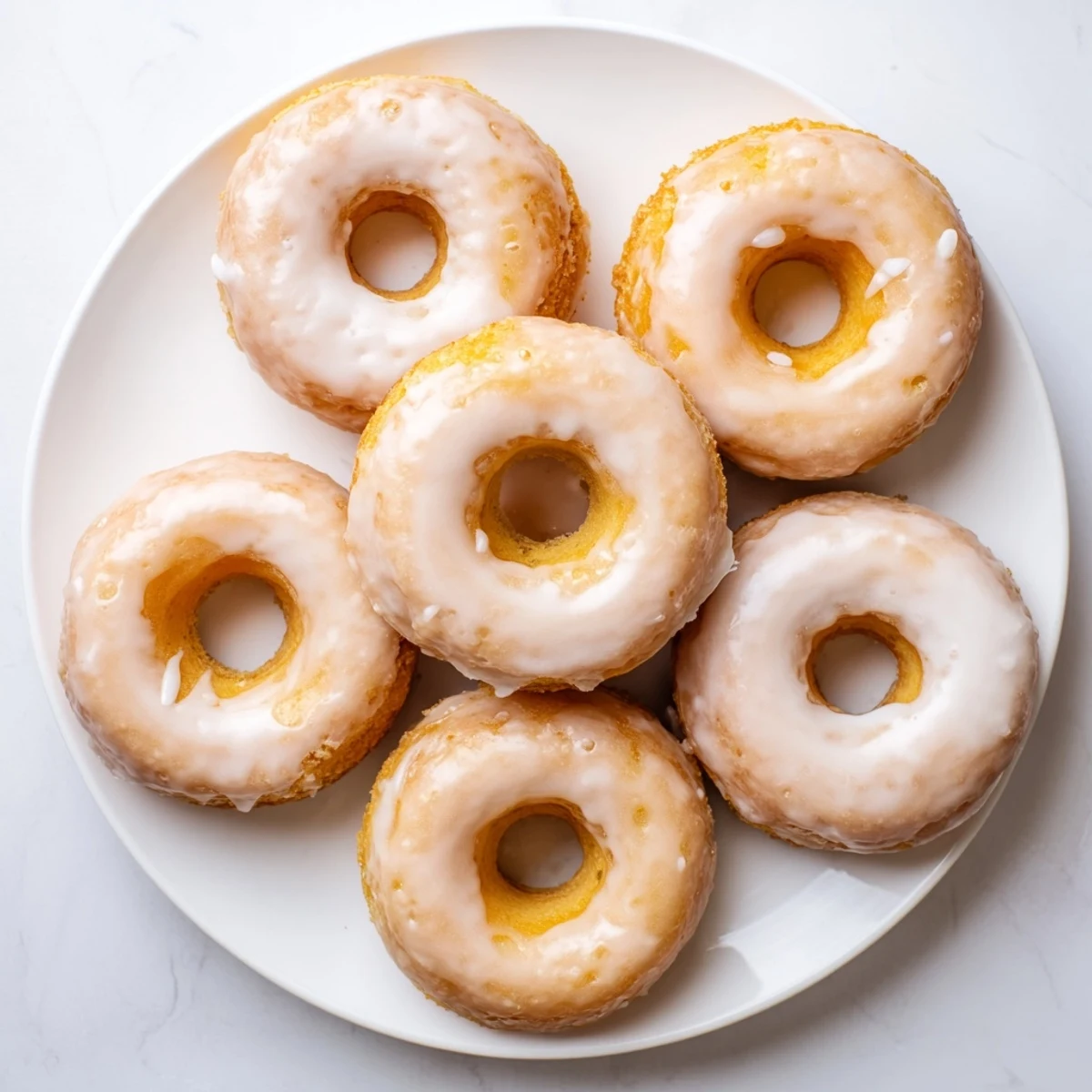 Golden baked Greek yogurt cake donuts with sweet vanilla glaze and sprinkles