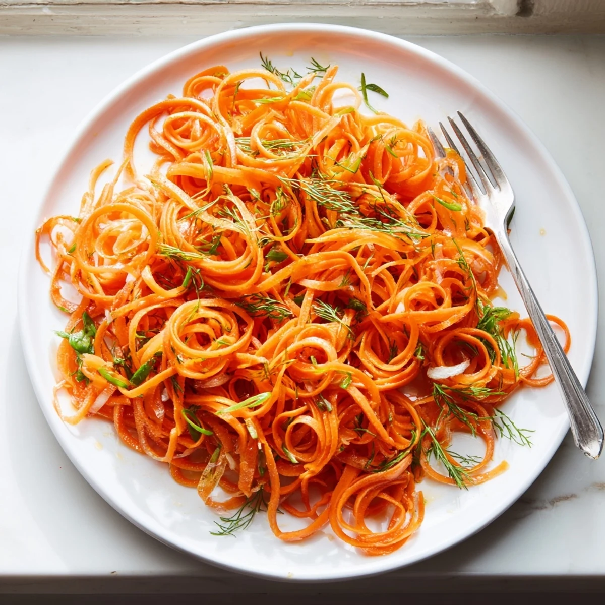 Crisp Marinated Lemon Dill Carrot Salad glistening with bright citrus dressing in a serving bowl