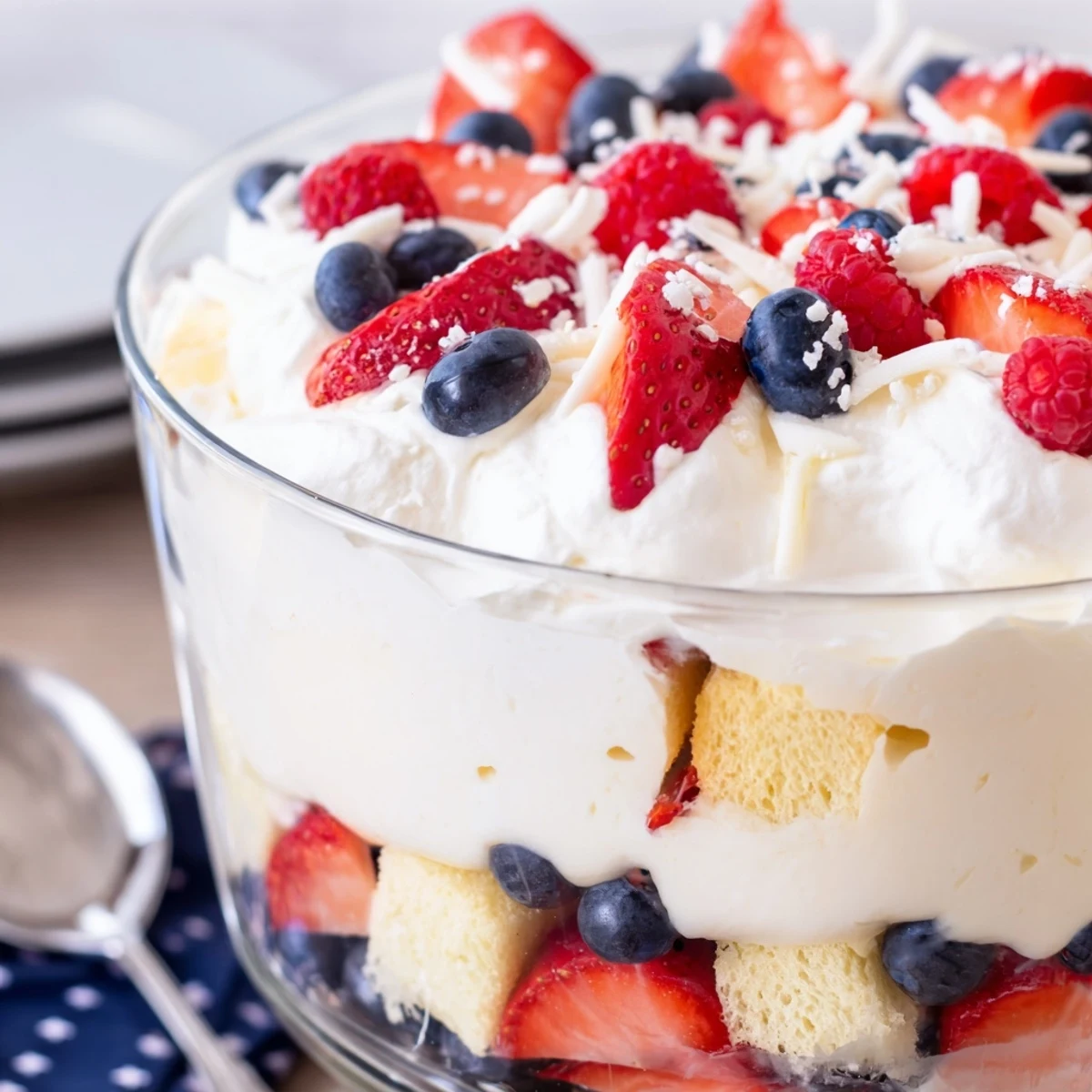 Red White And Blue Trifle overflowing with fresh berries and cloudlike whipped cream