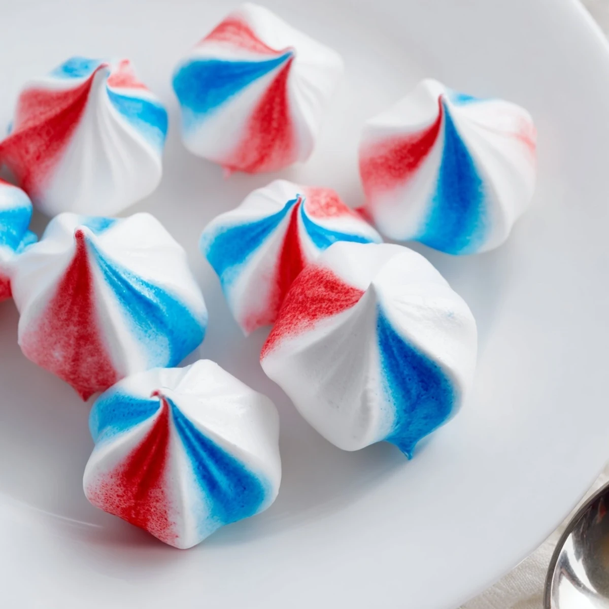 Patriotic Meringue Kisses arranged as party favors, crisp, sweet, festive display