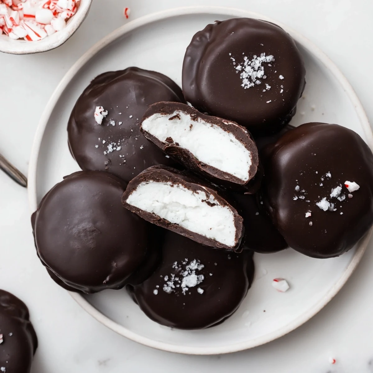 Tray of Peppermint Patties sprinkled with crushed candy, rich chocolate aroma