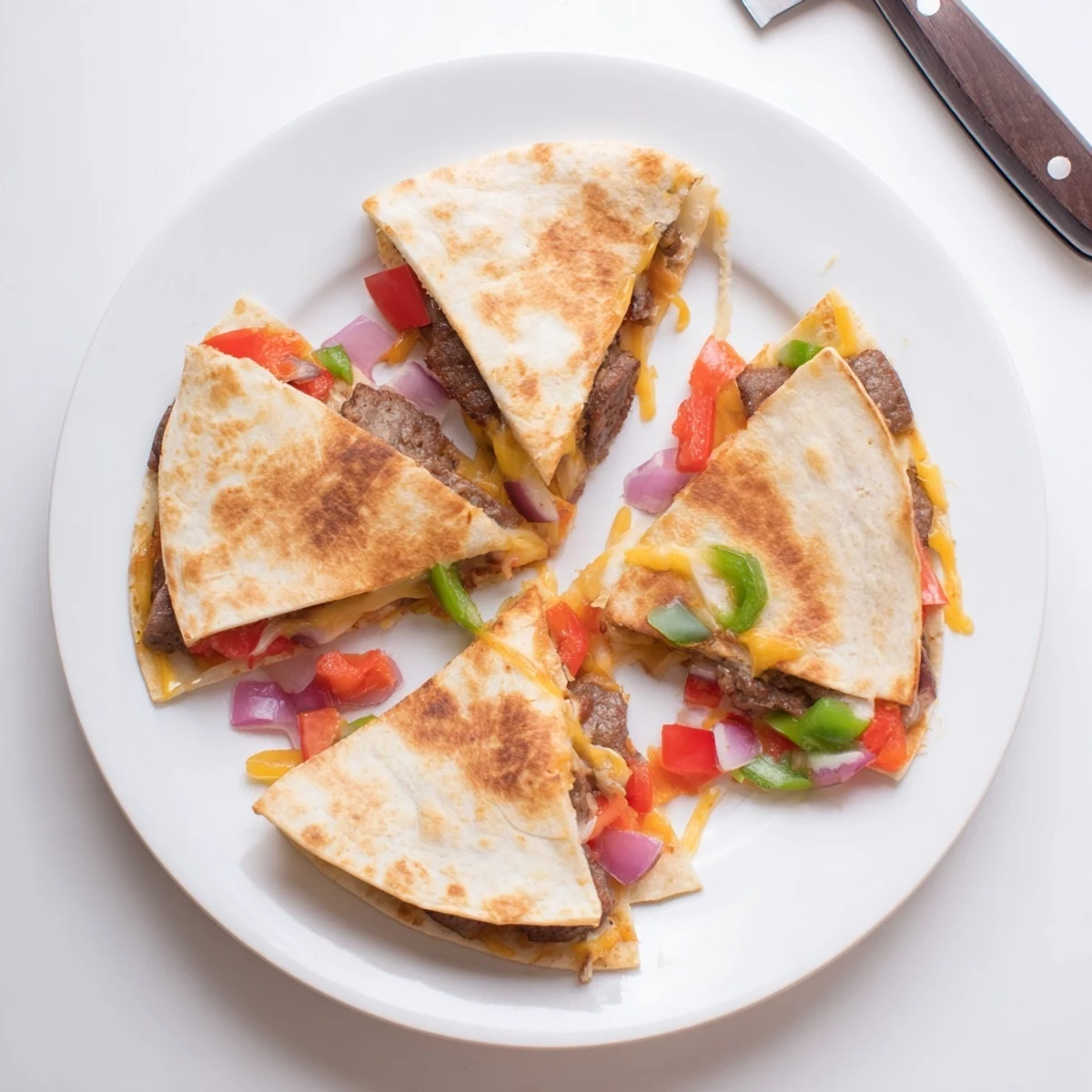 Golden brown Cajun beef sausage quesadillas with melted cheese oozing from crispy tortilla edges
