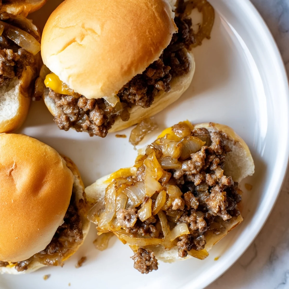 Hearty French onion beef sloppy joes piled high with savory ground beef and gooey Swiss cheese