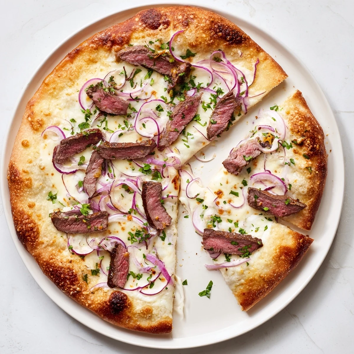 Creamy Alfredo sauce and melted cheeses cover this Beef Alfredo Pizza topped with seasoned beef strips