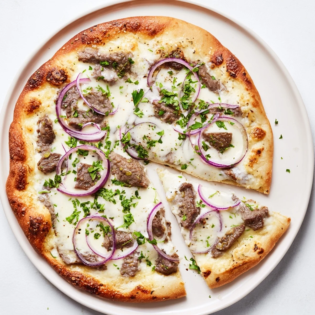 Golden Beef Alfredo Pizza with bubbling mozzarella and tender sliced beef on a rich cream sauce
