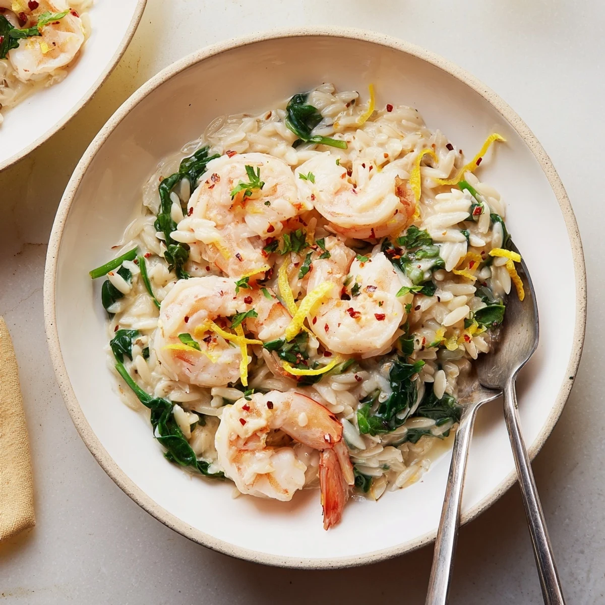 Pan-ready Creamy Shrimp Orzo Recipe showing golden-toasted orzo and wilted spinach