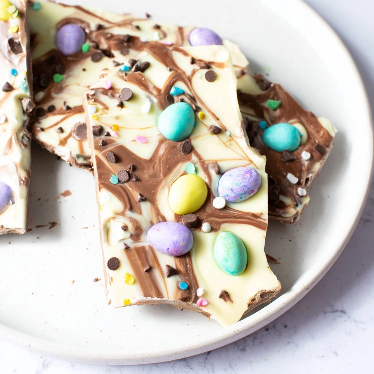 Tray of Robin Egg Easter Bark cooling on parchment, sweet egg candies