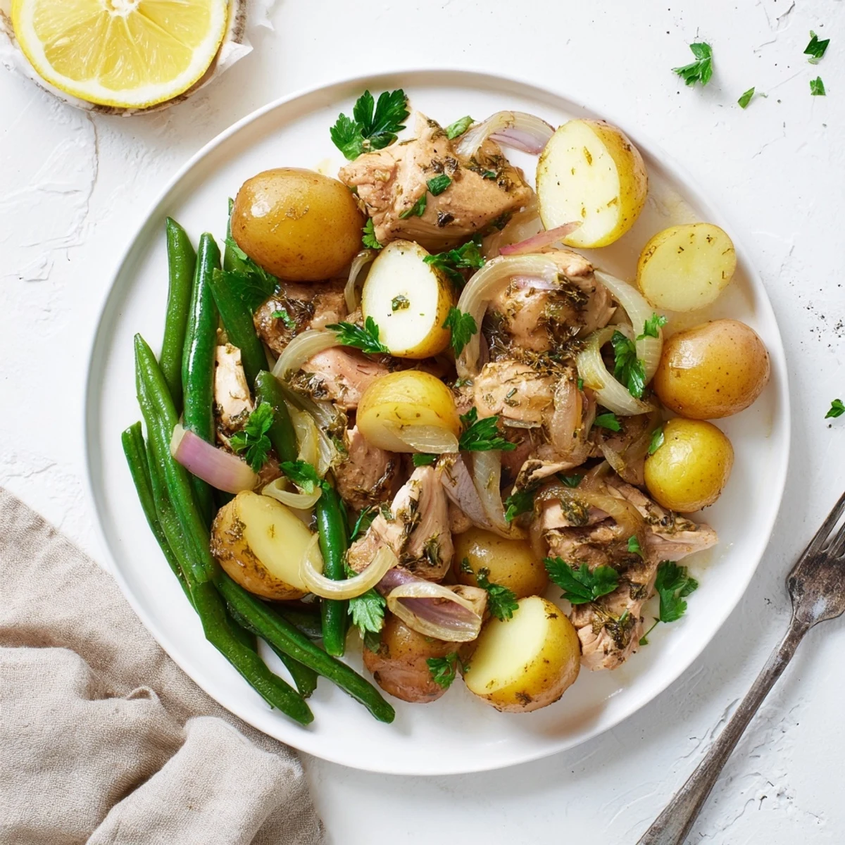 Golden slow cooker chicken and potatoes with green beans garnished with fresh parsley