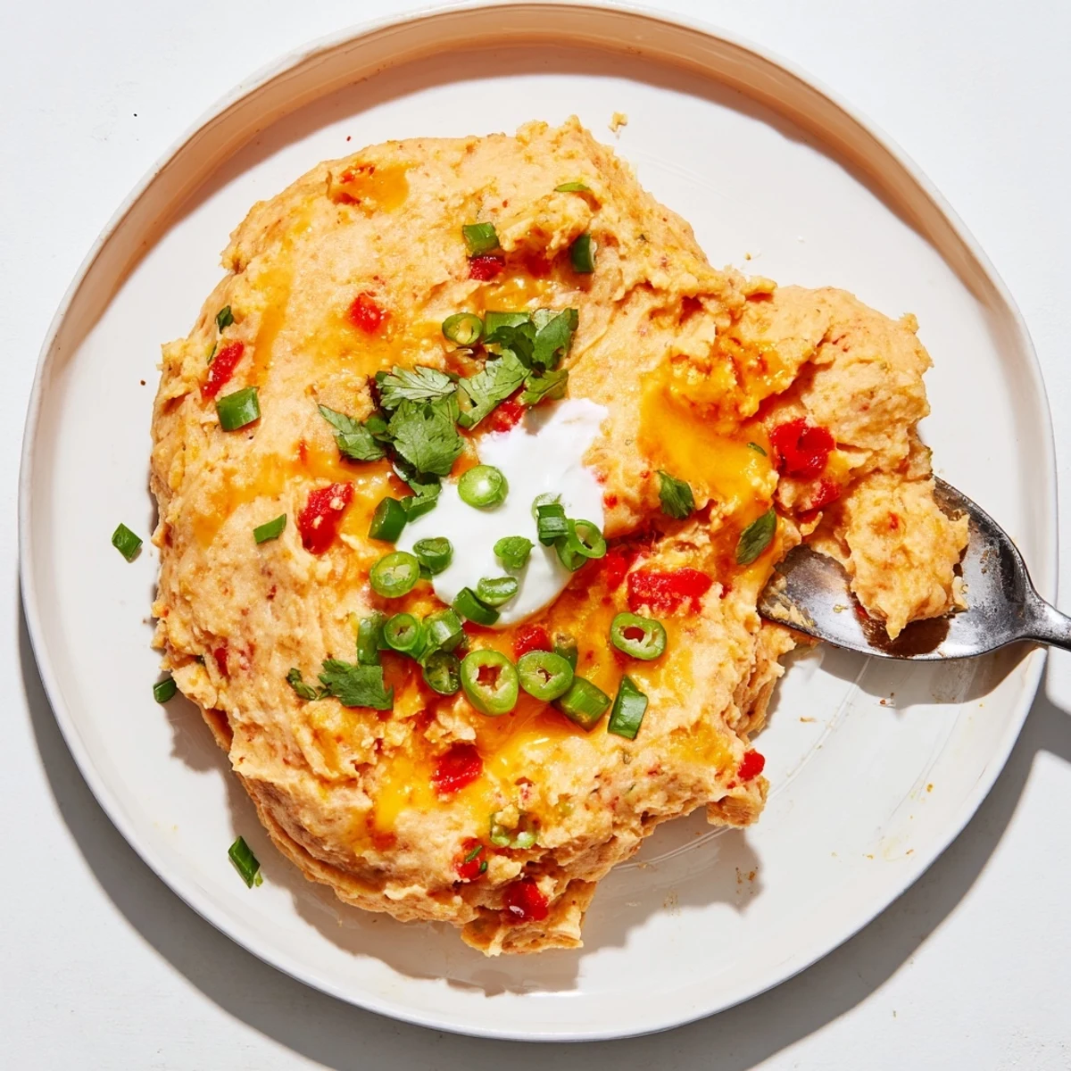 Creamy Tex Mex mashed potatoes topped with melted cheddar and fresh cilantro