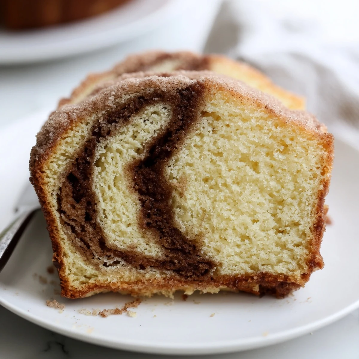 A tender cinnamon donut loaf fresh from the oven glistening with melted butter
