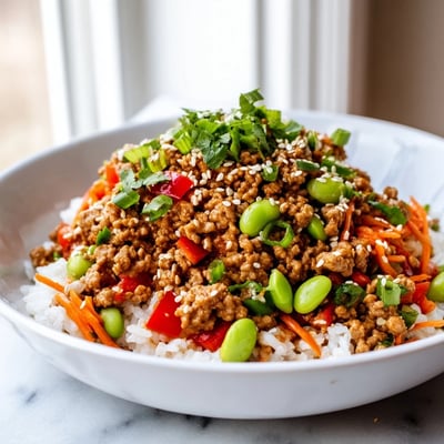 Colorful ground turkey rice bowls with sautéed bell peppers, carrots, and fluffy white rice